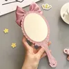 TSHOU632 Cute bowknot creative handle makeup mirror hand-held beauty salon makeup princess mirror portable mirror Pink color 240127