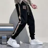 Herfst nieuwe high-end splitslintborduurwerk gepersonaliseerde sport- en casual broek voor heren slim fit Europese Harlem Guard-broek Trendy