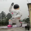 wholesale Doigt pointant vers le grand modèle d'astronaute gonflable rose ciel avec corde fixe et souffleur d'air pour la publicité ou