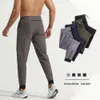 Mens Jogger Long Pants Sport Yoga outfit snabb torrt dragkammar Gymfickor Sweatpants Byxor Mense Casual Elastic Midje Fitness