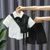 Ensemble pour enfants garçons à la mode patchwork noir et blanc chemise de bébé à simple boutonnage belle rue deux pièces de nouveaux vêtements d'été 240218