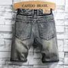 Jeans para hombres Hip Hop All-Match Denim Shorts Moda de verano Agujeros rectos sueltos Pantalones de mendigo Patrón Arruinado Parche