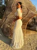 Robe sexy en dentelle blanche pour femmes, col roulé, manches à franges, taille nue ultra fine, manches longues creuses, plage d'été, robe tricotée 240219