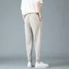 Spodnie męskie fajne tkaniny drape swobodne spodnie 2023 NOWA Moda streetwear harem małe stopy męskie spodnie biznesowe Khaki biały szary