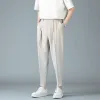 Spodnie męskie fajne tkaniny drape swobodne spodnie 2023 NOWA Moda streetwear harem małe stopy męskie spodnie biznesowe Khaki biały szary