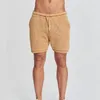Survêtements pour hommes deux pièces sexy creux tricots ensemble hommes hip hop à manches courtes col polo chemise cardigan top shorts plage pour hommes vêtements