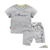 Set di abbigliamento Abiti estivi 0-13 anni Ragazzi Ragazze Lettera di marca stampata 100% cotone Arancione T-shirt Pantaloncini sportivi 2 pezzi Comodo per bambini Dh3C6