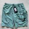 Projektant Europe Designer One Lens Pocket Pants Shorts Casual Dyed Beach Short Spit Bidshorts Swim Shorts Outdoor Jogging Rozmiar MXXL Black CP Designer55pd