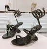 Elegant ny säsong Juniper Sandal Högkvalitativ vår/sommar Ny bredbandsmetall Snake Bone Wrapped Strap High Heel Women's Black Silver Gold Sandals