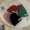 Berretti per bambini Cappello lavorato a maglia Semplice Lettera Etichetta in stoffa Tinta unita Bambino Lana Coreano Versatile Berretto pullover caldo