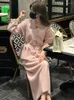 Arbetsklänningar 2024 vinterrosa elegant stickad tvådelar set kvinnor v hals vintage tröja midi kjol kostym kvinnlig koreansk mode avslappnad