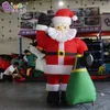 Groothandel 10mH (33ft) Retail reclame opblaasbare staande Kerstman draagtas opblaasbaar kerstkarakter voor feest evenement decoratie speelgoed sport