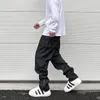 Pantaloni da uomo streetwear neri funzionali casual affusolati cargo con tasche impermeabili tuta con cerniera pieghettata abbigliamento in nylon