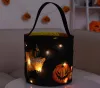 Novo balde de doces de Halloween com luz LED Cesta de Halloween Sacos de doces ou travessuras Sacola reutilizável Cestas de presentes de doces de abóbora para crianças, suprimentos para festas, lembrancinhas