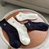 Chaussettes en coton femmes hommes classique respirant noir blanc mélange Football basket-ball sport chaussette concepteur luxe décontracté confort chaussette