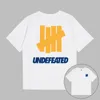 Этикетка с принтом Undefeated Мужские дизайнерские футболки Футболка с короткими рукавами UNDFTD Япония Мужская одежда 100% хлопок Футболки с рисунком Футболки больших размеров S-2XL