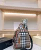 Mochila clásica de lona a cuadros con carácter, mochila de gran capacidad con bolsillo a rayas, cierre con cordón, bolso de marca de alta calidad