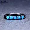 Anillos de boda JUNXIN Boho Femenino Anillo de piedra pequeña Ópalo de fuego azul para mujeres Bandas llenas de oro negro Piedra de nacimiento única