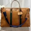 High-End Men's Travel Bag design axel handväska topp märke läder tryck spel tote bagage kvinnor mode utomhus affärs bred axel rem crossbody väska