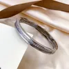 Högkvalitativ diamant armband designer armband kvinnor bokstav manschett lyxiga handledsmycken 18k guldpläterad rosguld rostfritt stål armbandsband acemanniska