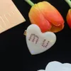 Resin peach heart earrings light luxury m IU tortoiseshell earrings women's hairpins wholesale