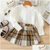 Ensembles de vêtements Nouvelles filles Jupe Deux pièces Ensemble Designer Vêtements pour enfants Bubble Sleeve Top Tissé Plaid Kirt Shorts Style européen et américain Dh2ng