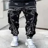 Mäns byxor herrbyxor Commodity 2023 Nya Sports Zipper Pockets Pants Bandana Mönster Tyg som kör herrbyxor P230529 L230915