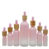 Frasco conta-gotas de vidro fosco Pipeta Gotejamento Cor rosa com tampa de bambu 1oz Frasco de óleo essencial 5ml 10ml 20ml 30ml 50ml 100ml Embalagem Cas Ckoq