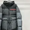 Men's Down Parkas Designer Winter 2023 Último diseñador Chaqueta de plumón de alta calidad Abrigo cálido al aire libre Moda Material de camuflaje Top Chaquetas para hombre 48B5