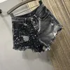 Pantaloncini da donna Estate Paillettes Denim Vita alta Pantaloni a trapezio da strada per ragazze con foro di grandi dimensioni