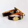 Bijoux de luxe de créateurs femmes bracelet en cuir avec coeur serrure matériel charme PU bracelets quatre feuilles motif de fleur sac en or Penda328E