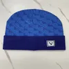 Europeiska designer snö beanies kvinnor män vinter ull mössor med kontrollerad stickad mode skid cap unisex märke skalle mössor varm hatt