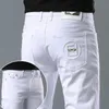 Jeans pour hommes Designer Printemps / Été Élastique Slim Fit Petits Pieds Casual Mode Polyvalent Jeunes Pantalons Longs Brodés OA1E