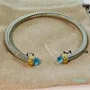 Bangle Cable Classic Collection Bracelet مع Topaz Blue و Black Onyx 18K Gold245C