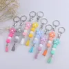 Porte-clés Design Silicone Porte-clés Couleur vive Perles de fleurs Bracelet Charme avec sac à pompon Pendentif Idées Cadeau pour elle 2023