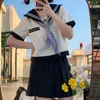 Robes de travail Japonais School Girls JK Uniforme Jupes Costume Preppy Style Femmes Bow Sailor Blouses Plissée Jupe Courte Classe Marine Costumes