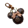 Designer porte-clés tête d'ours en cuir boule de fourrure pendentif porte-clés arc voiture pendentif en métal mode personnalité créative cute288L