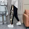 Мужские брюки Свободные спортивные штаны Jogger с буквенным принтом Модная уличная одежда в стиле хип-хоп Брюки в корейском стиле Новый люксовый бренд Мужская одежда J230926