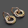 Boucles d'oreilles Carttiers Designer Luxe Mode FemmesNouvelle Tendance Haut de Gamme Sentiment Capable Atmosphère Diamant Incrusté Trois Couleurs Boucles D'oreilles Circulaires