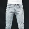 Slim Skinny Jeans Men Nouveau pantalon élastique de design coréen élastique Multi-bouton