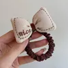 Accessori per capelli Autunno Latte Caffè Colore Lettera Bel fiocco di stoffa Fiore Fascia elastica alta per ragazza Carino durevole Bun Coda di cavallo Cravatte in gomma Regalo