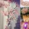 装飾的な花50pcsシルクチェリーブロッサムフラワーブランチベゴニアサクラツリーステムイベント結婚式の装飾人工sn
