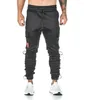 Pantaloni da uomo 2023 Primavera Uomo Pantaloni da jogging con tasche laterali Pantaloni della tuta casual Pantaloni Abbigliamento sportivo Bodybuilding