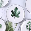 Tallrikar med gröna växter middag keramiska bordsformat och sätter upp middagar hushållsartiklar kök fruktplatta