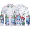 Erkekler Sıradan Gömlekler 23SS MENS TASARIMCI Gömle Kazabaş Hawaiian Oasis Adası Peyzaj Baskı Plaj Krallığı Boyalı Gevşek Tshirts Drop Dhtys