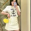 スカートデザイナーShenzhen Nanyou Womens Clothens CEファミリーショートスカート夏の新しいメタルボタン装飾アンチグレアハイウエストAラインEgko