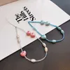 Cellband charms mobil lanyard kort lanyard handled band handbärande kreativ keramisk kärlek hänge kvinnors anti-förlorade slingrem