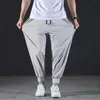 Männer Hosen Sommer Schnell trocknend Eis Seide Casual Ultra dünne Elastische Neun punkt Lose Drapieren Solide Strahl Füße 7XL 230808