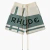 Fniy Men's and Women's High Street Shorts Fashion Brand Rhude 2023 Letter slogan Cashew Flower Plaid broderad dragsko lös stickad kvartal