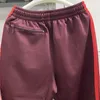 Pantalon pour hommes en poly lisse awge aiguilles sport mascules femmes broderie rouge papillon pantalon de survêtement